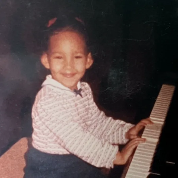 Young Gabrielle Faulkner at the piano.